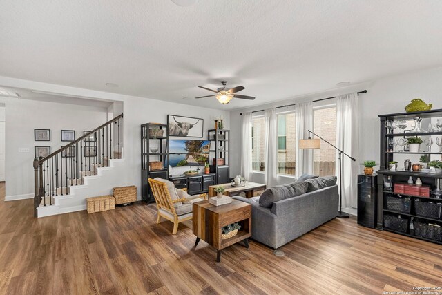 1527 Balcones Fault, New Braunfels, TX 78132 - living area with ceiling fan, wood finished floors, stairs, and baseboards