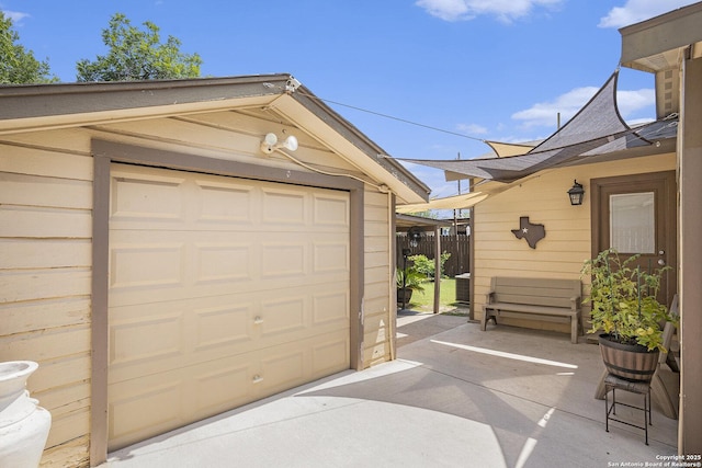 715 E Southcross, San Antonio, TX 78214 - garage featuring fence and concrete driveway