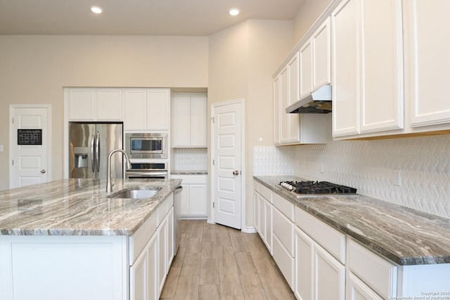 10809 Davis Farms, San Antonio, TX 78254 - kitchen featuring appliances with stainless steel finishes, under cabinet range hood, a sink, decorative backsplash, and white cabinetry