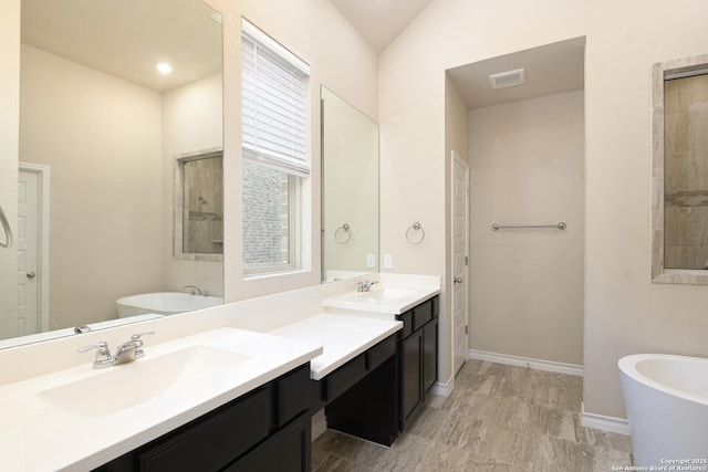 10809 Davis Farms, San Antonio, TX 78254 - full bath featuring a soaking tub, double vanity, and baseboards