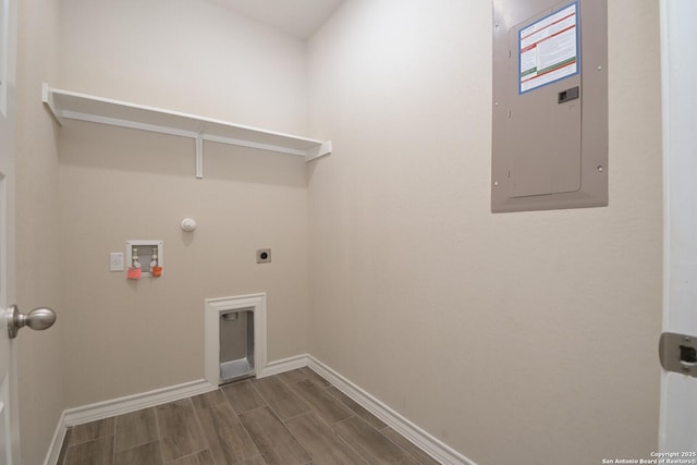 10809 Davis Farms, San Antonio, TX 78254 - washroom featuring electric panel, hookup for an electric dryer, baseboards, wood finish floors, and washer hookup