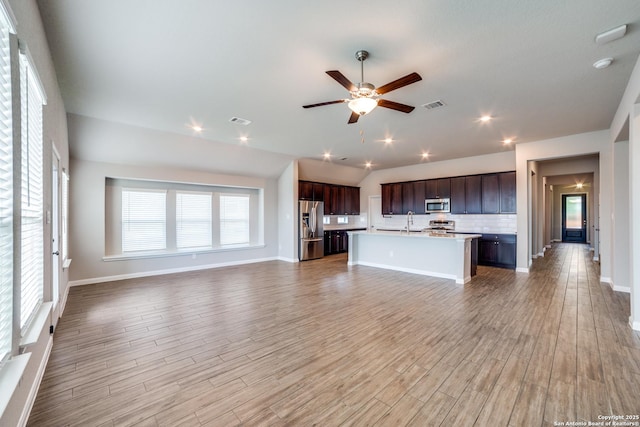 2010 Bailey Frst, San Antonio, TX 78253 - kitchen with stainless steel appliances, open floor plan, a sink, light countertops, and backsplash