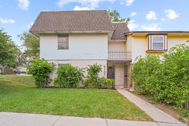6123 Farragut, San Antonio, TX 78238 - view of front of home with a balcony, a front lawn, a shingled roof, and brick siding