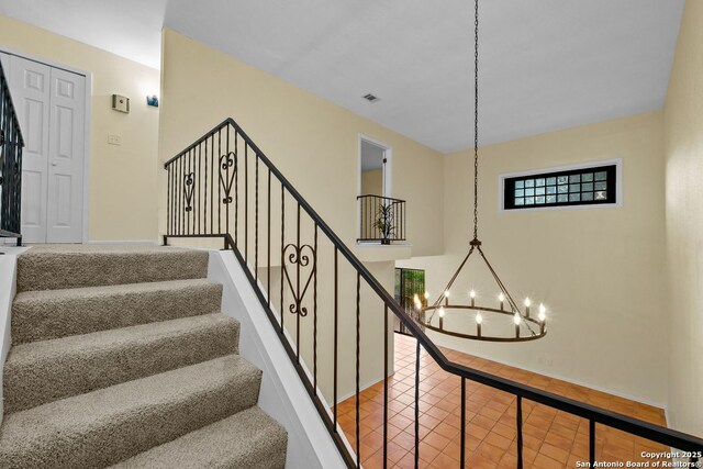 6123 Farragut, San Antonio, TX 78238 - staircase with a chandelier, baseboards, and tile patterned flooring