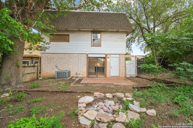 6123 Farragut, San Antonio, TX 78238 - back of house featuring brick siding, a gate, roof with shingles, central AC, and a fenced backyard