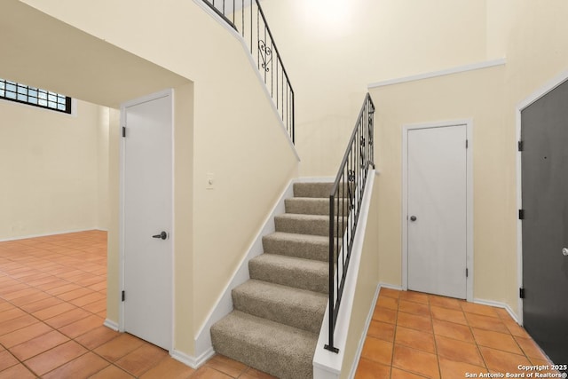 6123 Farragut, San Antonio, TX 78238 - stairway featuring tile patterned floors, a towering ceiling, and baseboards