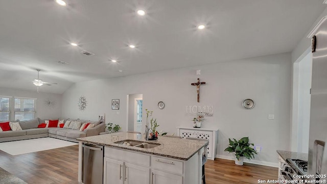 10535 Penelope, Converse, TX 78109 - kitchen featuring dishwasher, a ceiling fan, wood finished floors, white cabinetry, and light stone countertops