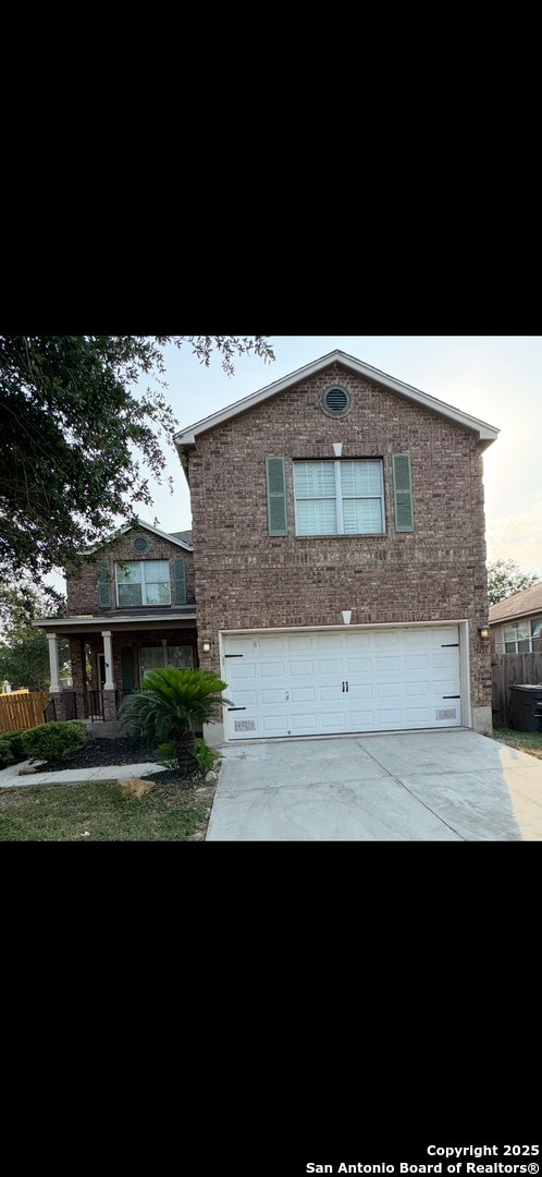7431 Bajo Luna, San Antonio, TX 78223 - traditional-style house featuring an attached garage, driveway, brick siding, and fence