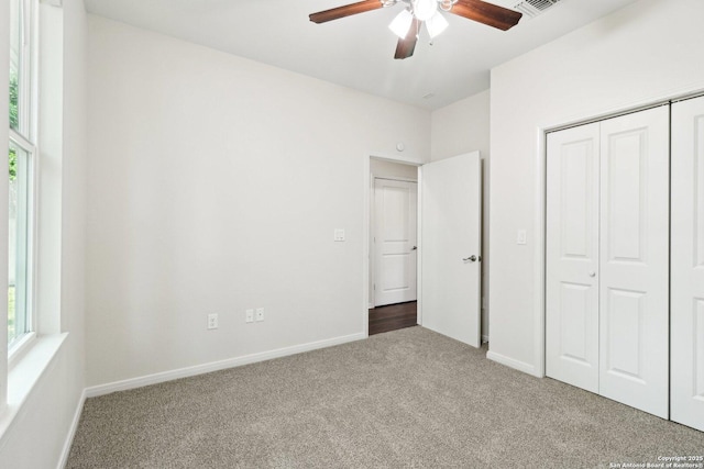 306 Joe Blanks St, San Antonio, TX 78237 - unfurnished bedroom with carpet flooring, a closet, baseboards, and a ceiling fan