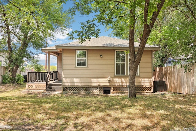 306 Joe Blanks St, San Antonio, TX 78237 - rear view of property with a wooden deck, cooling unit, and a shingled roof