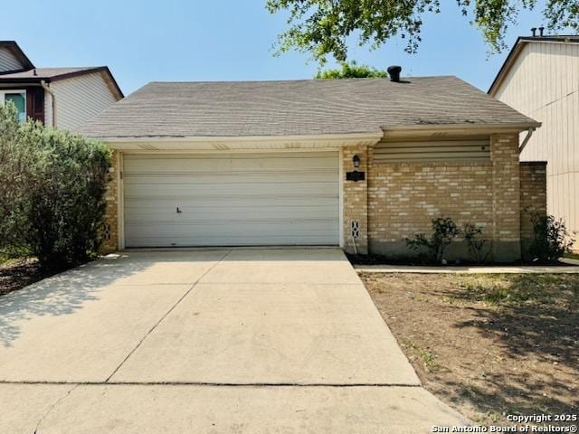 5739 Spring Moon, San Antonio, TX 78247 - view of front of property with a garage, brick siding, and concrete driveway