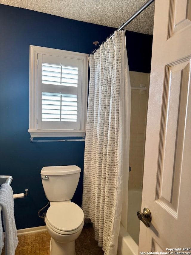 5739 Spring Moon, San Antonio, TX 78247 - full bathroom with toilet, shower / bath combo, a textured ceiling, and baseboards