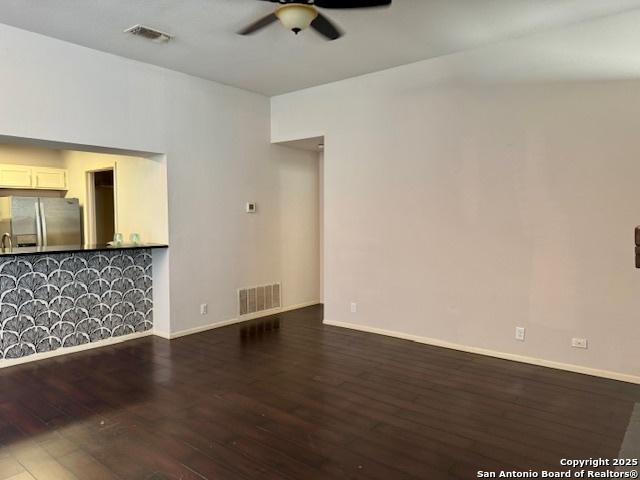 5739 Spring Moon, San Antonio, TX 78247 - unfurnished living room with a ceiling fan, wood finished floors, and baseboards