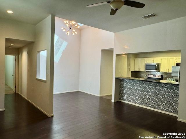 5739 Spring Moon, San Antonio, TX 78247 - kitchen with appliances with stainless steel finishes, dark wood-type flooring, ceiling fan, backsplash, and baseboards