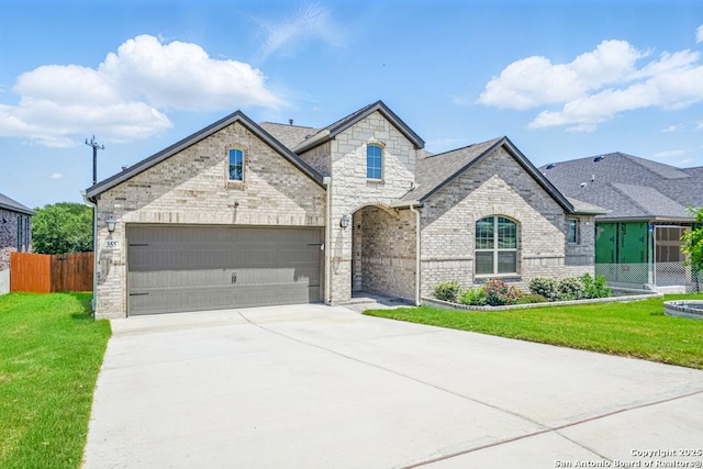 355 Jereth, Castroville, TX 78009 - french country home with concrete driveway, brick siding, an attached garage, and stone siding