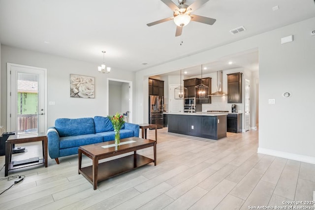 355 Jereth, Castroville, TX 78009 - living room featuring light wood-style flooring, a chandelier, a ceiling fan, baseboards, and recessed lighting