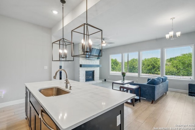 355 Jereth, Castroville, TX 78009 - kitchen featuring a sink, open floor plan, a chandelier, baseboards, and recessed lighting