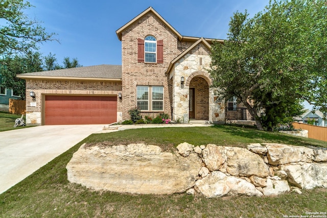 29121 Ismorada, San Antonio, TX 78260 - view of front of property featuring brick siding, concrete driveway, an attached garage, and stone siding