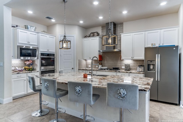 29121 Ismorada, San Antonio, TX 78260 - kitchen featuring stainless steel appliances, wall chimney exhaust hood, backsplash, light stone countertops, and recessed lighting