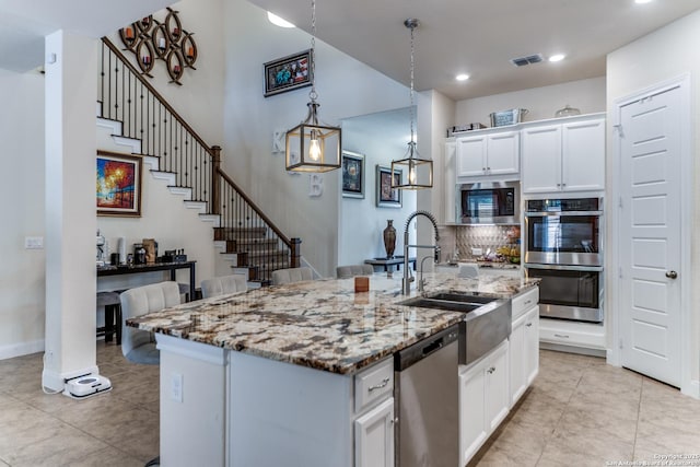29121 Ismorada, San Antonio, TX 78260 - kitchen featuring stainless steel appliances, a sink, light stone counters, white cabinets, and recessed lighting