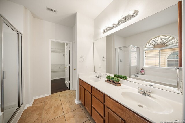 17026 Darien Wing, San Antonio, TX 78247 - bathroom featuring a shower stall, double vanity, tile patterned flooring, a walk in closet, and a garden tub