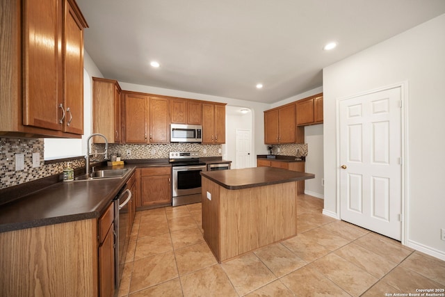 17026 Darien Wing, San Antonio, TX 78247 - kitchen featuring appliances with stainless steel finishes, a sink, dark countertops, backsplash, and a center island