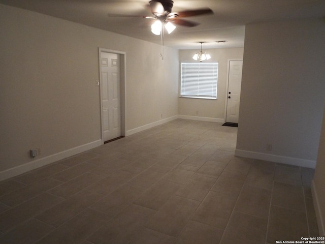 225 Zephyr, Windcrest, TX 78239 - unfurnished room with ceiling fan, a chandelier, baseboards, and tile patterned flooring