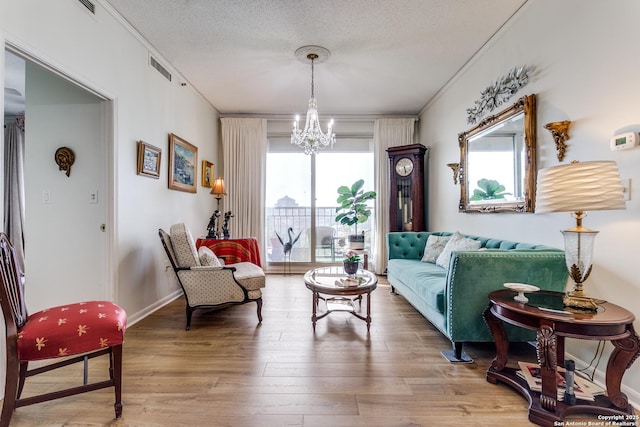 1 Towers Park Ln Unit 907, San Antonio, TX 78209 - living room with a chandelier, wood finished floors, ornamental molding, a textured ceiling, and baseboards