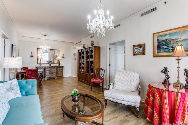 1 Towers Park Ln Unit 907, San Antonio, TX 78209 - living room featuring a chandelier, wood finished floors, and ornamental molding