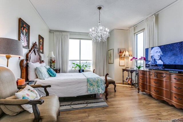 1 Towers Park Ln Unit 907, San Antonio, TX 78209 - bedroom with a chandelier and wood finished floors