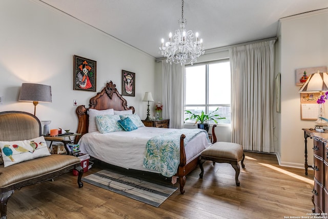 1 Towers Park Ln Unit 907, San Antonio, TX 78209 - bedroom with a chandelier, wood finished floors, and baseboards