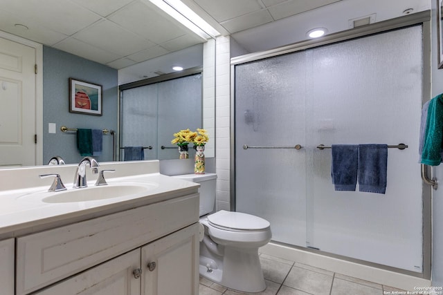 1 Towers Park Ln Unit 907, San Antonio, TX 78209 - bathroom with tile patterned flooring, a shower stall, a drop ceiling, toilet, and vanity