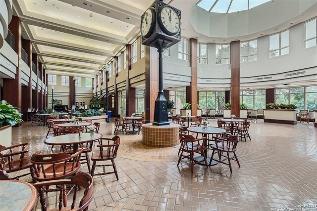 1 Towers Park Ln Unit 907, San Antonio, TX 78209 - dining room featuring a towering ceiling, a wood stove, and brick flooring