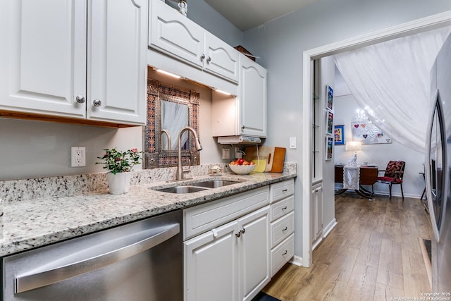 1 Towers Park Ln Unit 907, San Antonio, TX 78209 - kitchen featuring stainless steel appliances, a sink, white cabinetry, and light wood-style floors