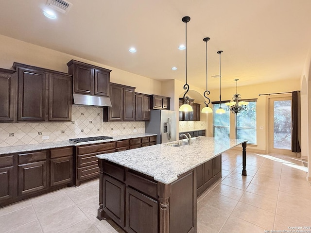 4419 Tapia, San Antonio, TX 78261 - kitchen with stainless steel fridge with ice dispenser, light tile patterned floors, gas cooktop, under cabinet range hood, and backsplash
