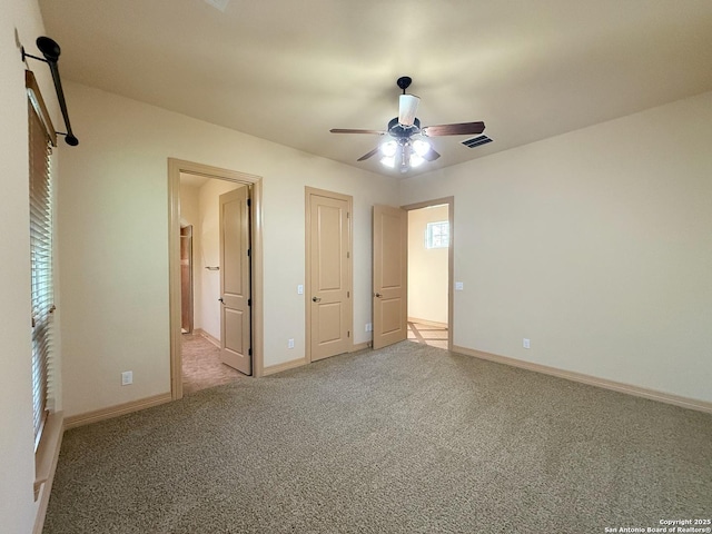 4419 Tapia, San Antonio, TX 78261 - unfurnished bedroom with light carpet, baseboards, connected bathroom, and ceiling fan