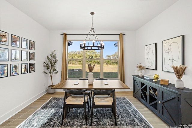 187 Stone Loop, Castroville, TX 78009 - dining space with a chandelier, light wood finished floors, and baseboards