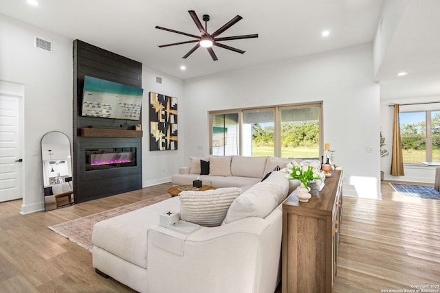 187 Stone Loop, Castroville, TX 78009 - living room with a ceiling fan, a fireplace, wood finished floors, recessed lighting, and baseboards