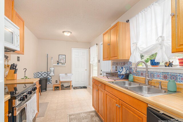 926 Zwicke, Seguin, TX 78155 - kitchen featuring electric stove, white microwave, a sink, light flooring, and dishwasher