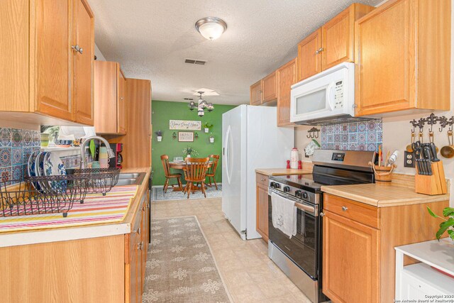 926 Zwicke, Seguin, TX 78155 - kitchen with white appliances, a sink, light countertops, and a textured ceiling