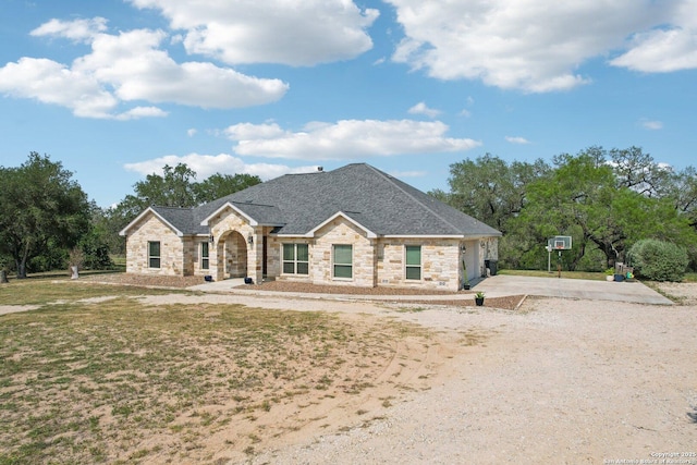 346 Broken Arrow, Floresville, TX 78114 - french country inspired facade featuring stone siding, driveway, and roof with shingles