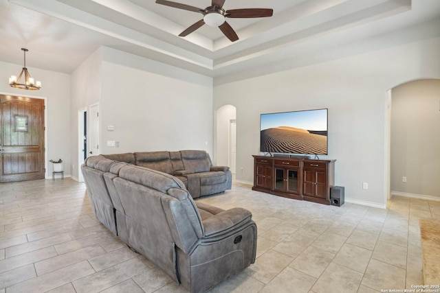 346 Broken Arrow, Floresville, TX 78114 - living area with arched walkways, a tray ceiling, ceiling fan, and a chandelier