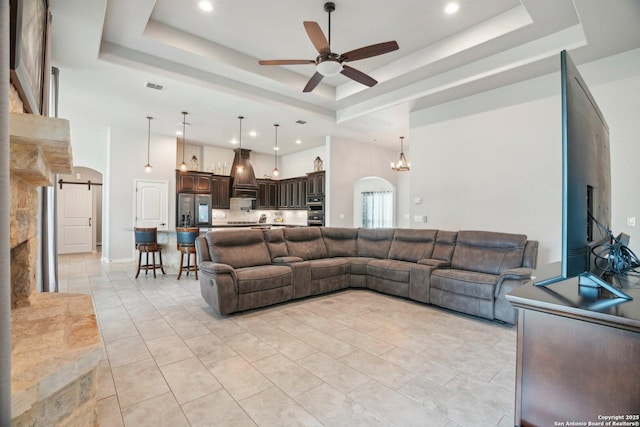346 Broken Arrow, Floresville, TX 78114 - living area with ceiling fan, a raised ceiling, arched walkways, recessed lighting, and a towering ceiling