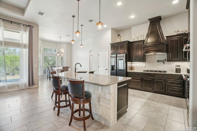 346 Broken Arrow, Floresville, TX 78114 - kitchen with stainless steel appliances, premium range hood, a sink, decorative backsplash, and recessed lighting