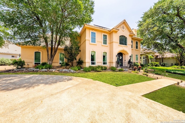19114 Autumn, San Antonio, TX 78258 - mediterranean / spanish house with stucco siding, a front lawn, and roof mounted solar panels