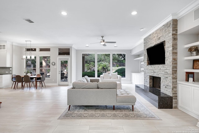 7 Caleb Cir, San Antonio, TX 78258 - living room featuring ceiling fan, crown molding, recessed lighting, a stone fireplace, and baseboards
