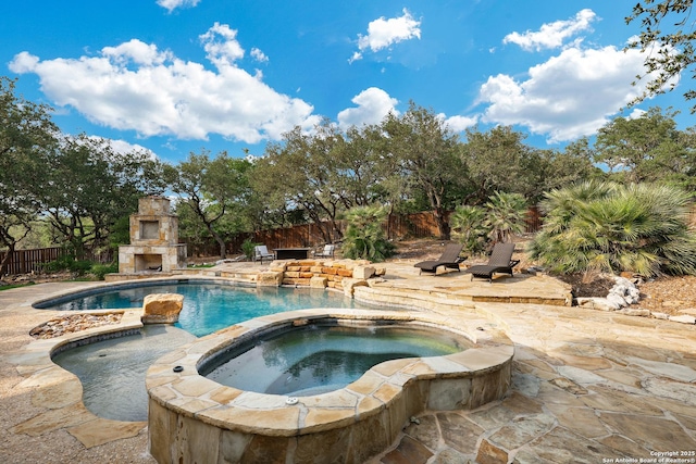 7 Caleb Cir, San Antonio, TX 78258 - view of swimming pool with an outdoor stone fireplace, a patio, fence, and an in-ground hot tub