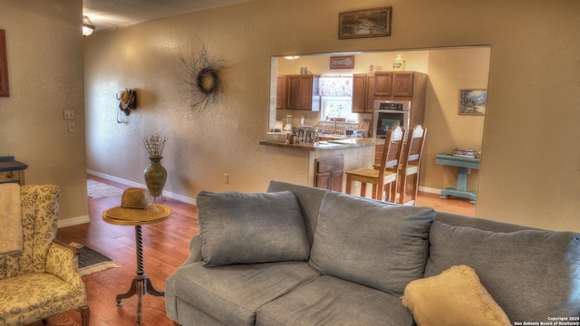 211 Roy Chisum Rd, Leakey, TX 78873 - living area with light wood finished floors, baseboards, and a textured wall