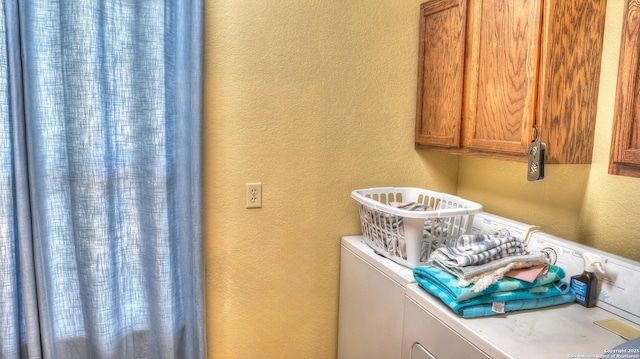 211 Roy Chisum Rd, Leakey, TX 78873 - laundry area with independent washer and dryer, a textured wall, and cabinet space