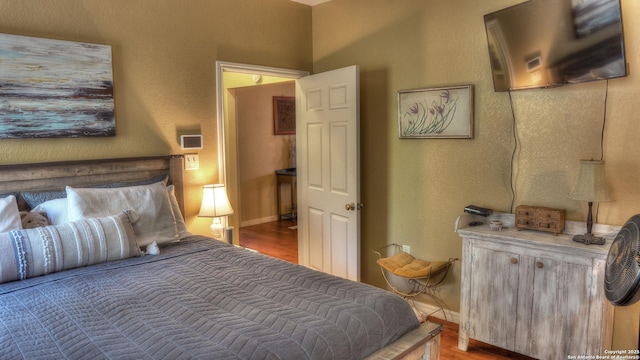 211 Roy Chisum Rd, Leakey, TX 78873 - bedroom with wood finished floors and baseboards